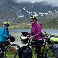 dr. Leslie & riding partner on bicycles in the fjords of norway.